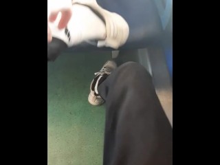 white socks and sneakers. a guy jerks off a dick through jeans in an empty train