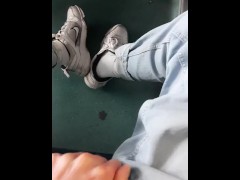 a young guy in blue jeans sneakers and white socks jerks off on an empty train in Milan