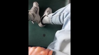 a young guy in blue jeans sneakers and white socks jerks off on an empty train in Milan