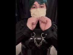 Girl cuffs her self in a latex catsuit