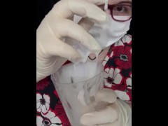 Girl plays with cum in medical gear