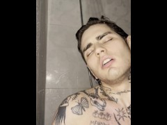 Tattooed young guy jerking off in the shower