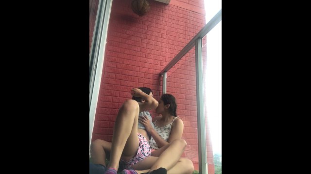 Hot girls film themselves kissing and touching each other on the balcony