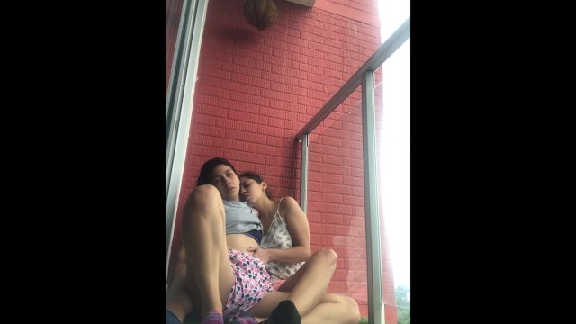 Hot girls film themselves kissing and touching each other on the balcony