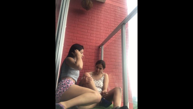 Hot girls film themselves kissing and touching each other on the balcony