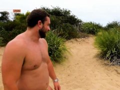 Hunky daddy Koby Falks relaxes at the beach before getting his uncut cock sucked in the dunes