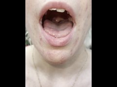 A nice blondie is coughing and spitting close up