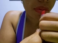 Ebony girl with full lips seduces you while applying lipstick