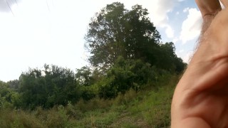 Big Dick Cumming in a field