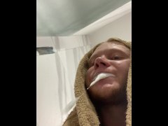 A handsome guy brushes his teeth and spits