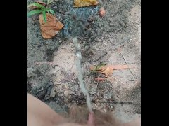Girl pisses in wood on dry ground